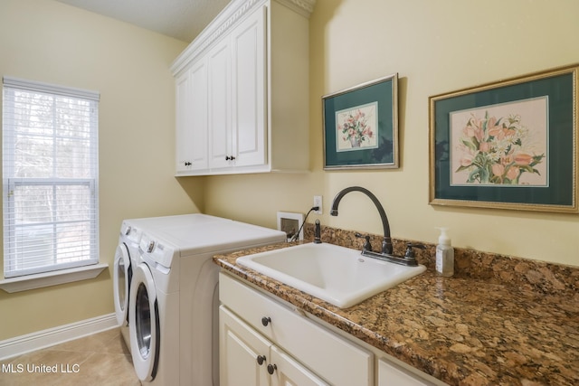 washroom with cabinets, separate washer and dryer, sink, and light tile patterned floors