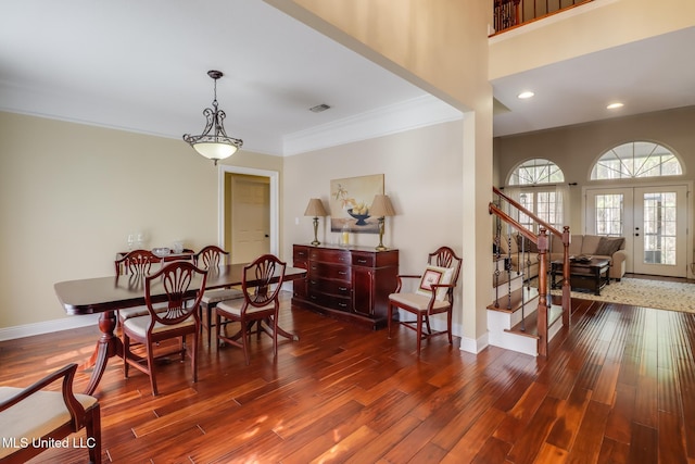 dining area featuring french doors, ornamental molding, and dark hardwood / wood-style floors