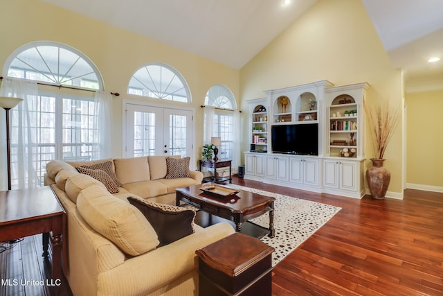 living room with dark wood-type flooring, high vaulted ceiling, and french doors