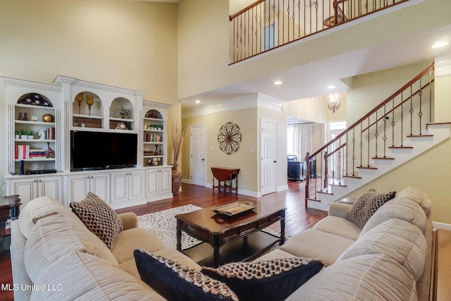 living room featuring a high ceiling and hardwood / wood-style floors