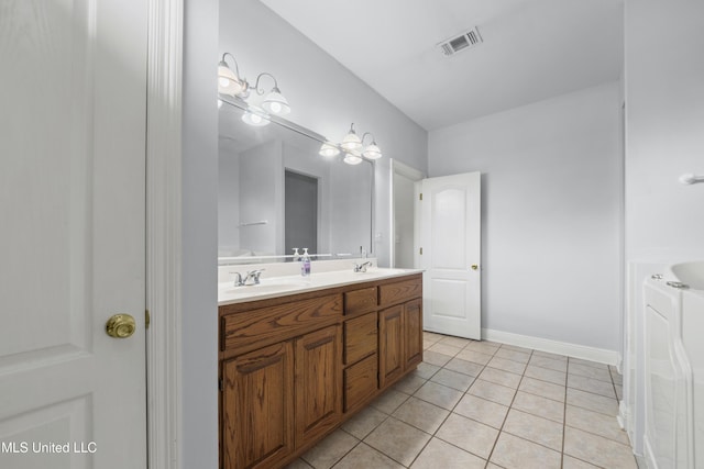 725 Old Savannah Dr, Long Beach, MS 39560 - full bath featuring double vanity, tile patterned floors, and baseboards