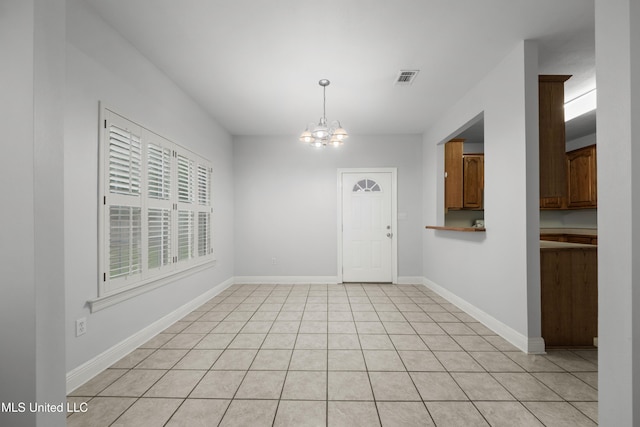 725 Old Savannah Dr, Long Beach, MS 39560 - unfurnished dining area with a chandelier, baseboards, and light tile patterned flooring
