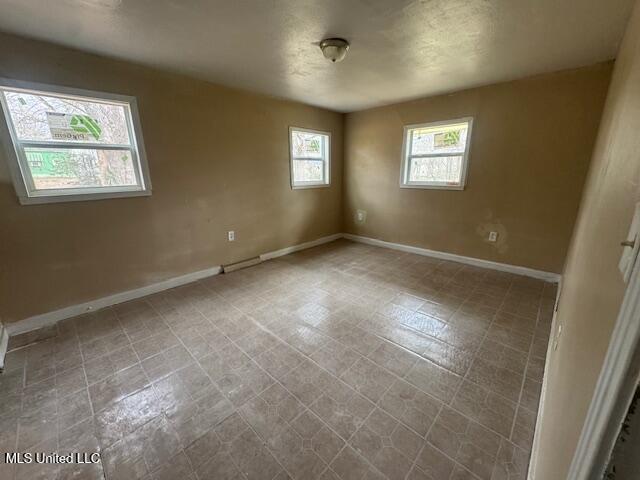 empty room with baseboards