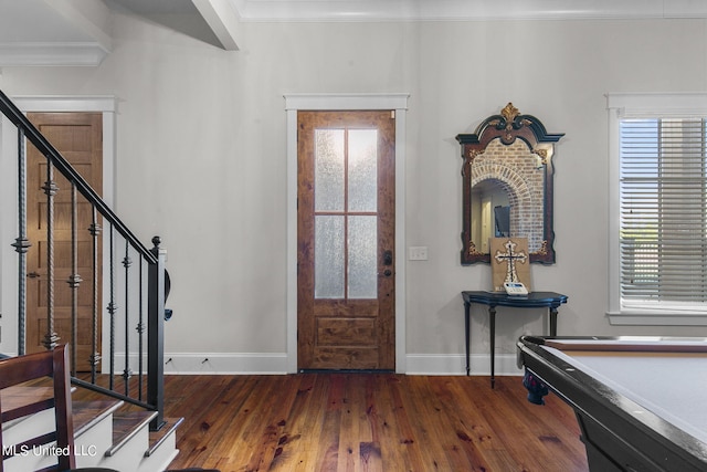 foyer featuring crown molding, dark hardwood / wood-style flooring, and pool table