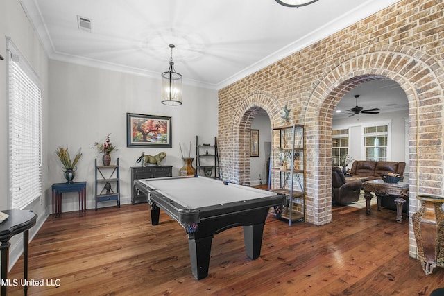 rec room featuring pool table, dark hardwood / wood-style floors, brick wall, crown molding, and ceiling fan