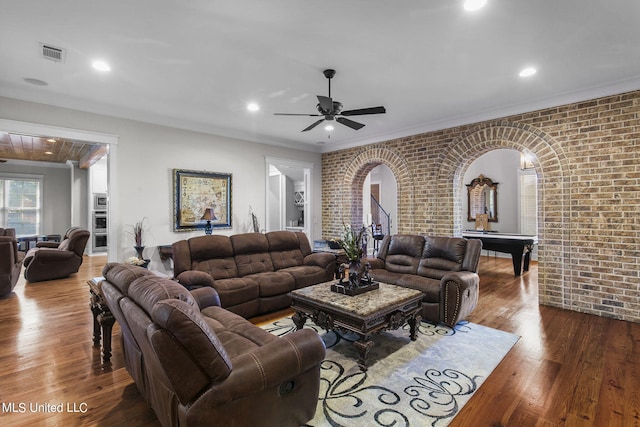 living room featuring pool table, brick wall, crown molding, dark hardwood / wood-style flooring, and ceiling fan