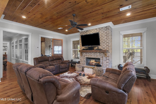 living room with ornamental molding, wood ceiling, dark hardwood / wood-style floors, and a fireplace