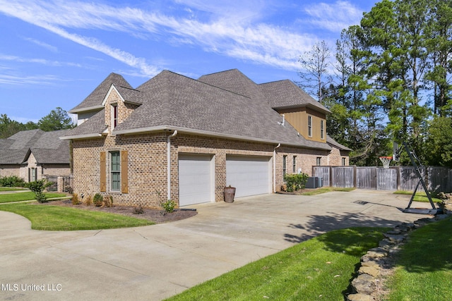 view of side of home featuring central AC, a lawn, and a garage