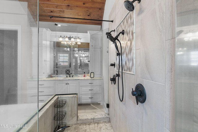 bathroom featuring vanity, vaulted ceiling, wooden ceiling, and walk in shower