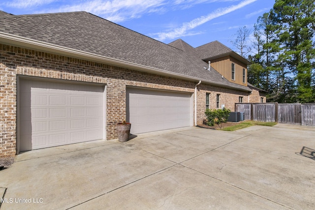 view of property exterior with central AC and a garage