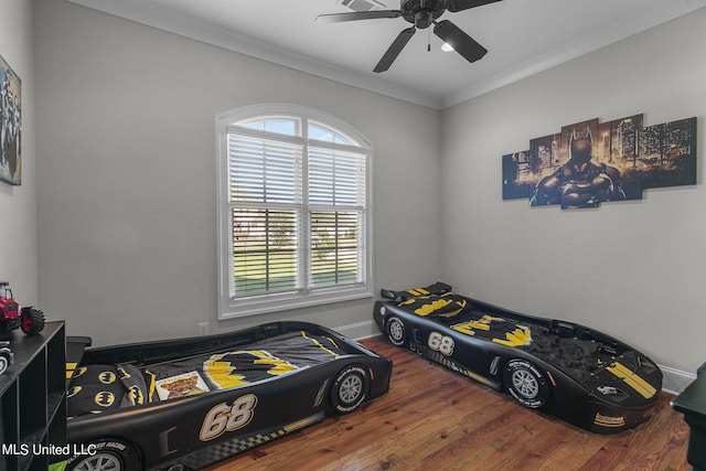 bedroom featuring ceiling fan, hardwood / wood-style flooring, and ornamental molding