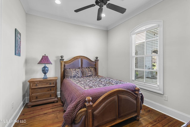 bedroom with ornamental molding, dark hardwood / wood-style floors, and ceiling fan