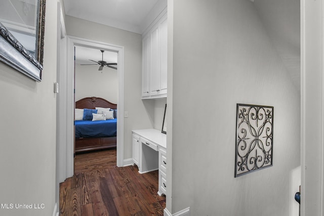 corridor with dark hardwood / wood-style flooring