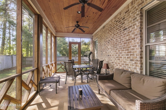 sunroom / solarium featuring wooden ceiling and ceiling fan