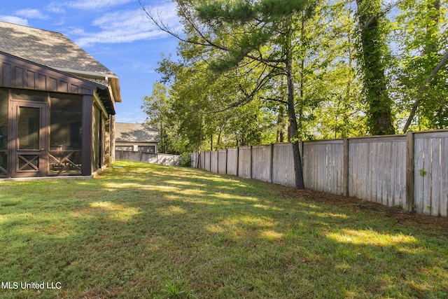 view of yard with a sunroom