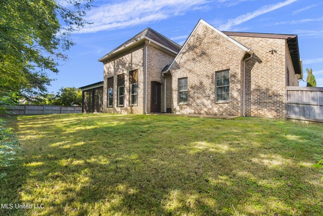 213 Ironwood Plantation Blvd, Madison, MS 39110 - back of property with a lawn, brick siding, and fence