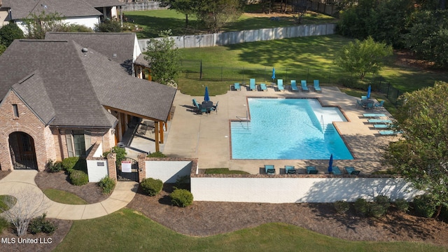 view of swimming pool with a yard and a patio