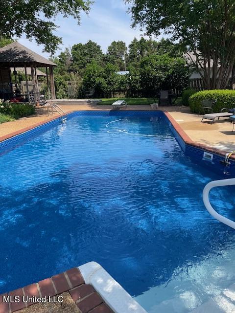 806 Viney Ridge Rd, Clarksdale, MS 38614 - swimming pool with a gazebo, a patio, a diving board, and fence