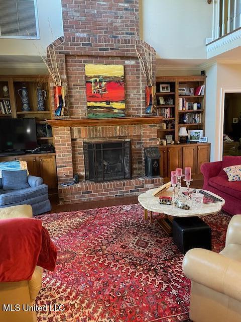 806 Viney Ridge Rd, Clarksdale, MS 38614 - living room with a high ceiling, a fireplace, crown molding, and built in features