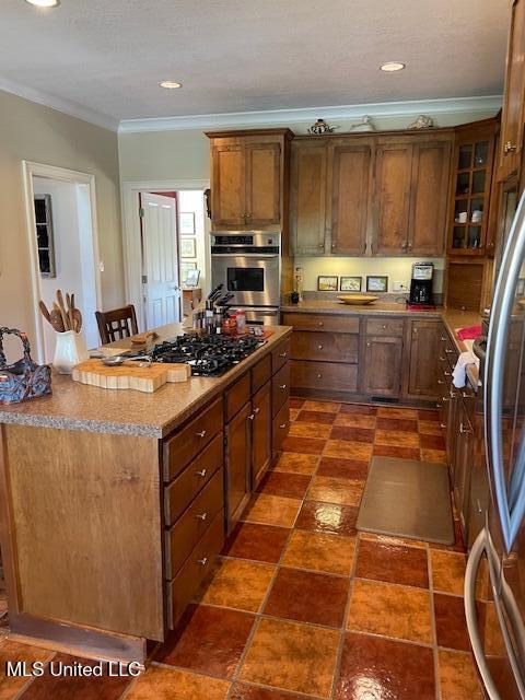 806 Viney Ridge Rd, Clarksdale, MS 38614 - kitchen featuring crown molding, stainless steel appliances, glass insert cabinets, a kitchen island, and recessed lighting