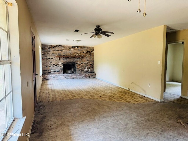55 Amacker Rd, Poplarville, MS 39470 - unfurnished living room with a ceiling fan, a brick fireplace, and tile patterned floors