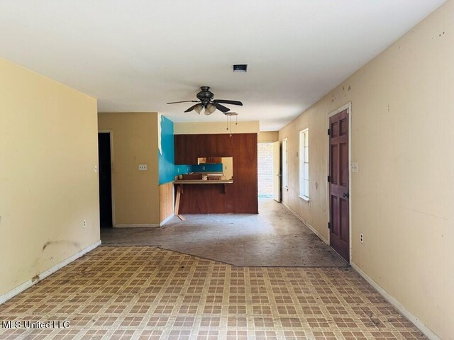 55 Amacker Rd, Poplarville, MS 39470 - unfurnished living room featuring a ceiling fan and baseboards