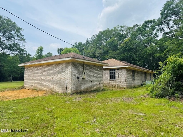 55 Amacker Rd, Poplarville, MS 39470 - view of property exterior with a lawn and brick siding