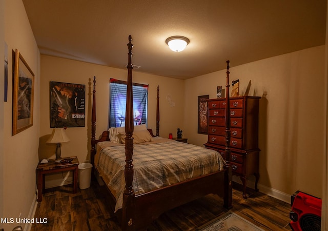 bedroom with dark wood-type flooring