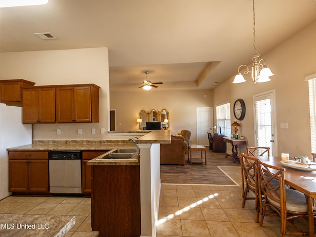 kitchen featuring sink, stainless steel dishwasher, decorative light fixtures, ceiling fan with notable chandelier, and light wood-type flooring