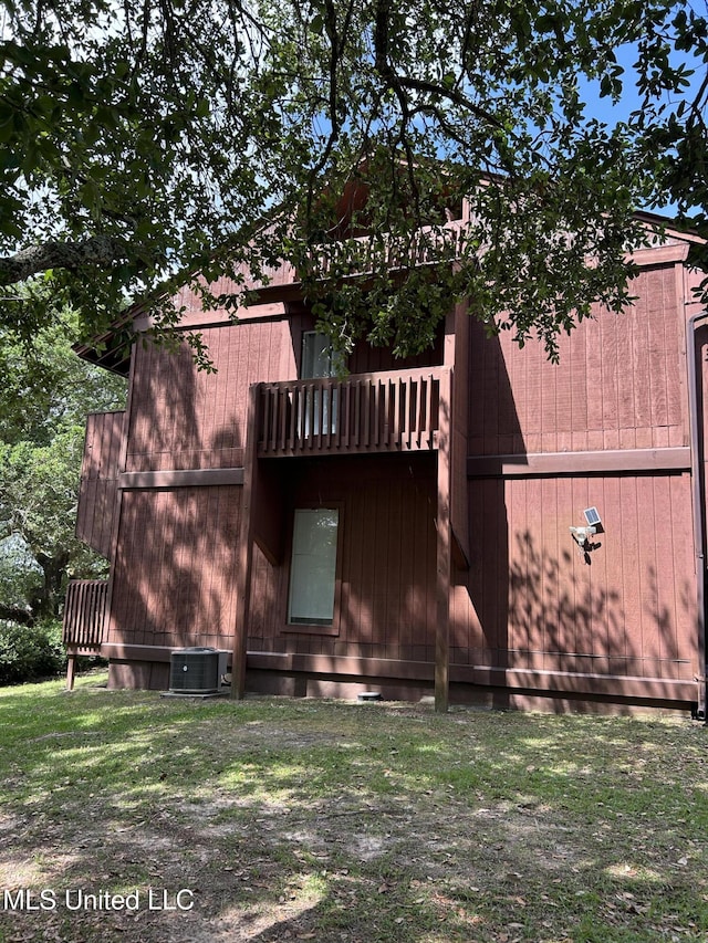 150 Lakeside Villa Unit J, Diamondhead, MS 39525 - rear view of house featuring central air condition unit and crawl space