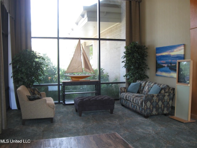150 Lakeside Villa Unit J, Diamondhead, MS 39525 - carpeted living room featuring floor to ceiling windows and healthy amount of natural light