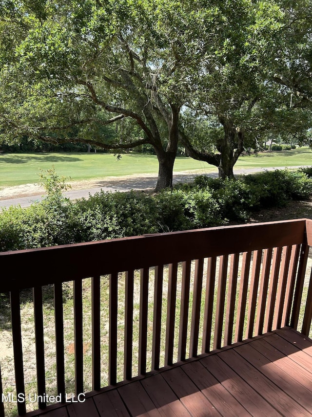 150 Lakeside Villa Unit J, Diamondhead, MS 39525 - deck with view of scattered trees and a lawn