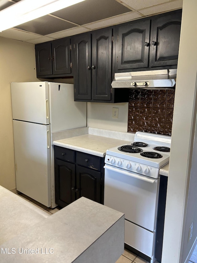 150 Lakeside Villa Unit J, Diamondhead, MS 39525 - kitchen with white appliances, under cabinet range hood, light countertops, and dark cabinets