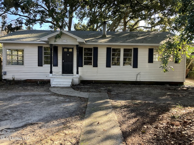 single story home featuring roof with shingles