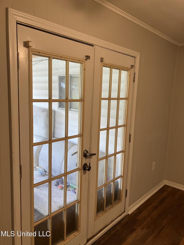 doorway with french doors, dark wood finished floors, baseboards, and crown molding