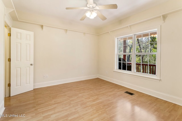 empty room featuring hardwood / wood-style floors and ceiling fan