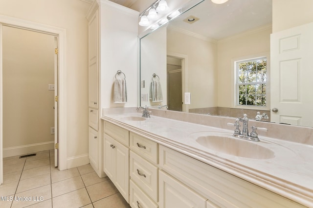 bathroom with vanity, crown molding, and tile patterned flooring