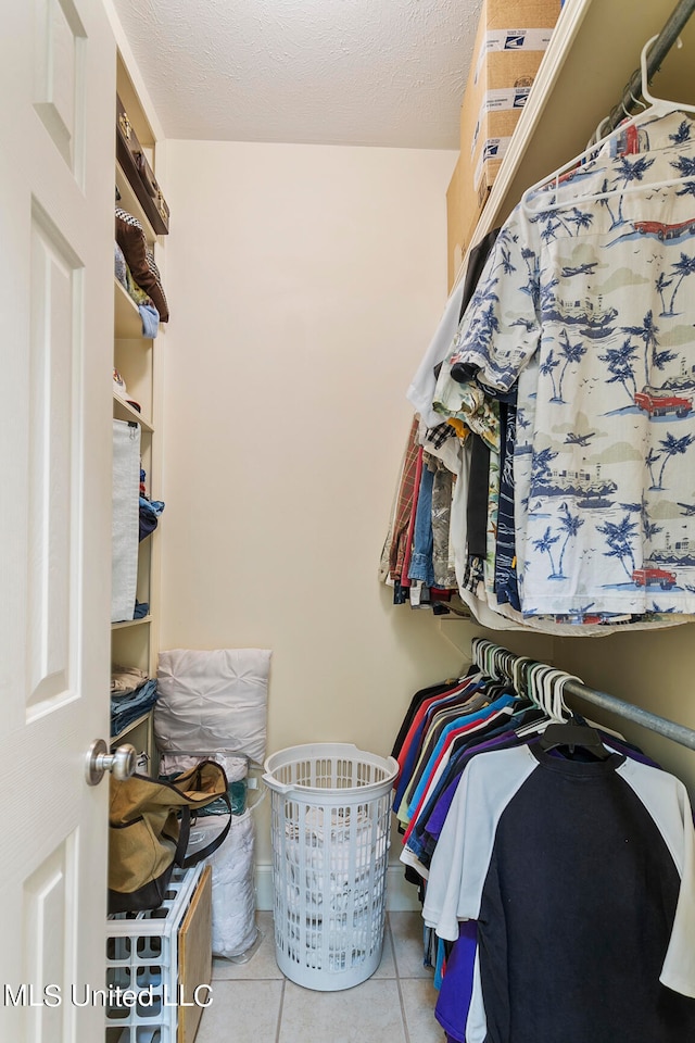 spacious closet with light tile patterned flooring