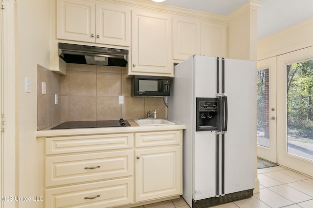 kitchen with black appliances, sink, backsplash, ornamental molding, and light tile patterned floors