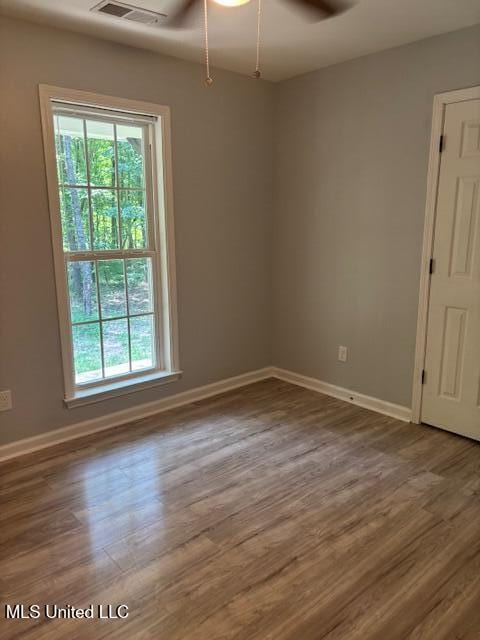 81 Hickory, Byhalia, MS 38611 - empty room with plenty of natural light, wood finished floors, and a ceiling fan