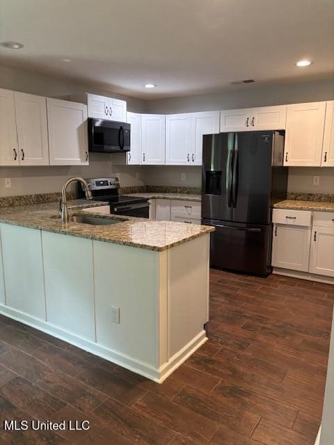 81 Hickory, Byhalia, MS 38611 - kitchen featuring black appliances, light stone countertops, recessed lighting, white cabinetry, and a peninsula