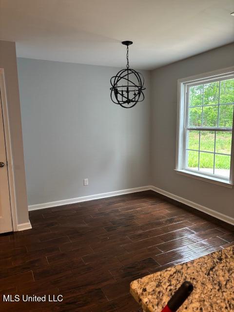 81 Hickory, Byhalia, MS 38611 - spare room featuring dark wood-style floors and a chandelier