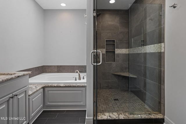 415 Spike Rdg, Canton, MS 39046 - full bathroom featuring a garden tub, tile patterned floors, vanity, a stall shower, and recessed lighting