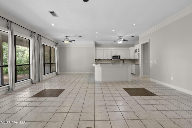 415 Spike Rdg, Canton, MS 39046 - kitchen featuring ornamental molding, open floor plan, a ceiling fan, backsplash, and light tile patterned flooring