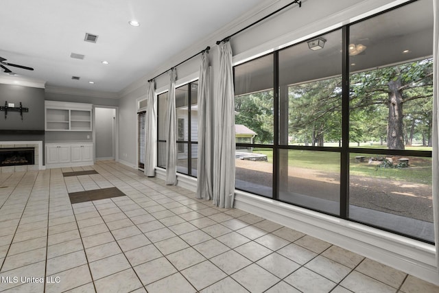 415 Spike Rdg, Canton, MS 39046 - unfurnished living room featuring light tile patterned floors, ornamental molding, a fireplace, a ceiling fan, and recessed lighting