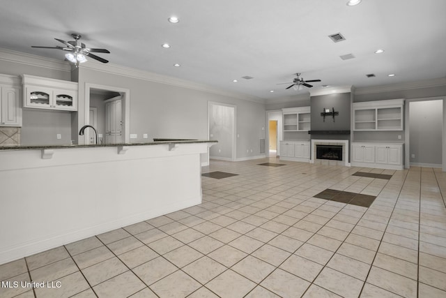 415 Spike Rdg, Canton, MS 39046 - unfurnished living room featuring a ceiling fan, recessed lighting, a tile fireplace, baseboards, and ornamental molding