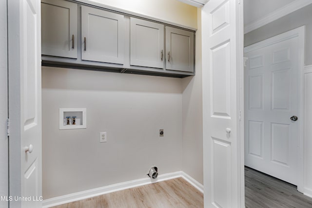 5415 Sollie Cv, Horn Lake, MS 38637 - laundry area with light wood-style flooring, baseboards, hookup for a washing machine, cabinet space, and ornamental molding