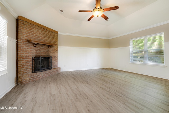 5415 Sollie Cv, Horn Lake, MS 38637 - unfurnished living room featuring a tray ceiling, wood finished floors, visible vents, a ceiling fan, and a brick fireplace