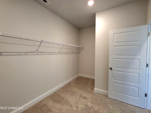 spacious closet with light carpet and visible vents