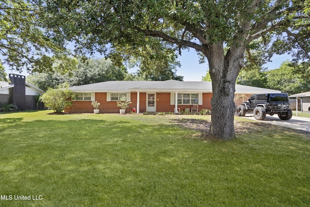 single story home featuring concrete driveway, a front lawn, and brick siding